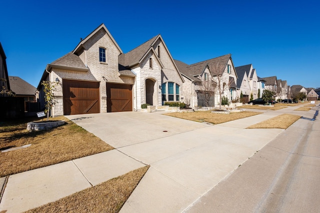 french provincial home with a garage