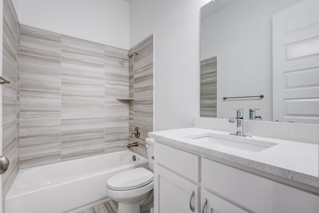 full bathroom with tiled shower / bath combo, vanity, and toilet