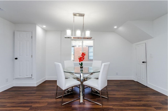 dining room with lofted ceiling, dark wood-type flooring, and a notable chandelier