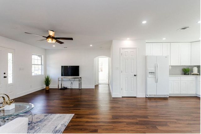 unfurnished living room with dark hardwood / wood-style floors and ceiling fan