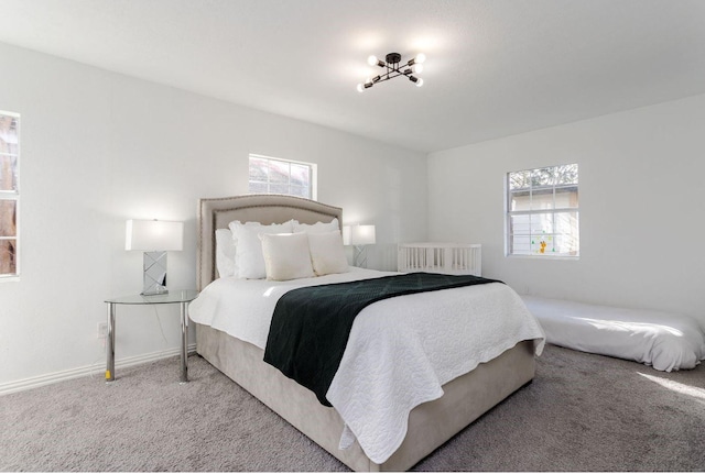 carpeted bedroom with multiple windows