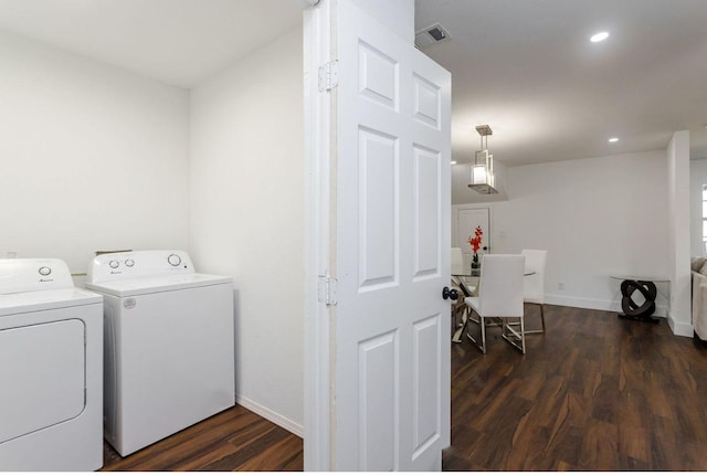 laundry room with dark hardwood / wood-style flooring and separate washer and dryer