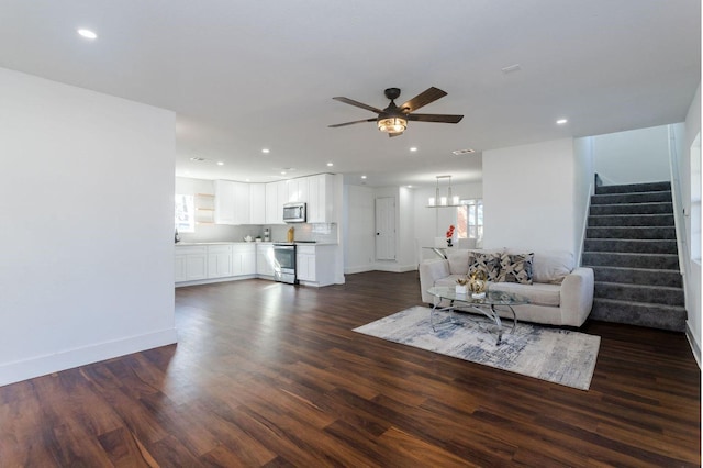 living room with dark hardwood / wood-style floors and ceiling fan