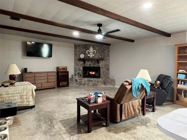 living room featuring a ceiling fan, beam ceiling, and a fireplace