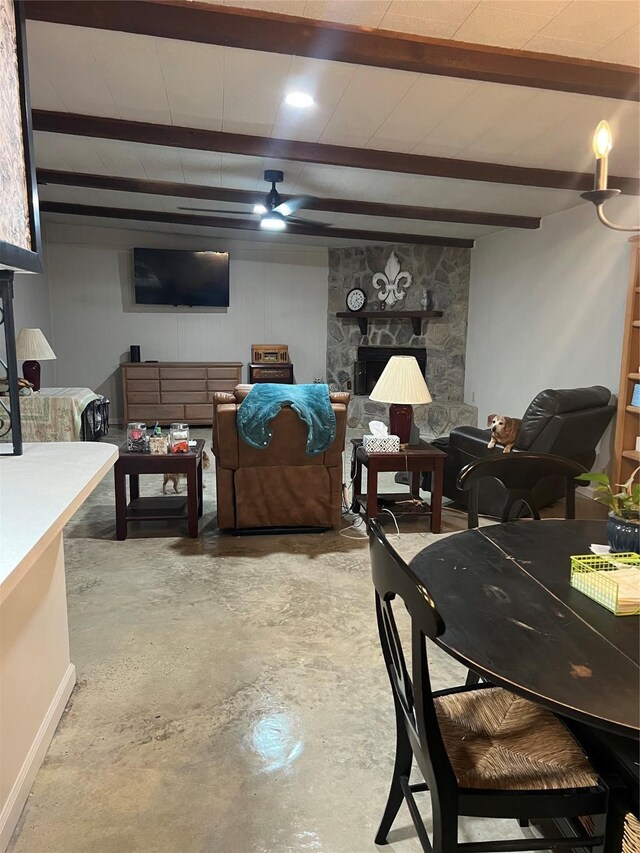 interior details featuring a fireplace, concrete flooring, and beamed ceiling