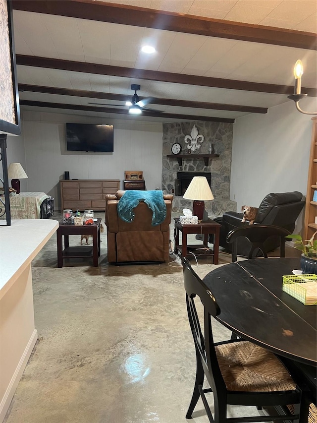 living area featuring beam ceiling, concrete flooring, and ceiling fan