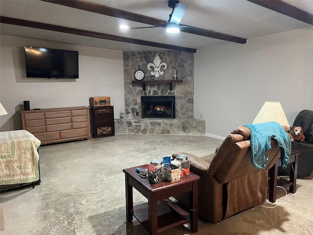 living room with ceiling fan, beam ceiling, and a stone fireplace