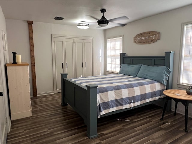 bedroom featuring visible vents, baseboards, a closet, and dark wood-style flooring