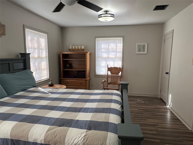 bedroom with visible vents, baseboards, ceiling fan, and wood finished floors