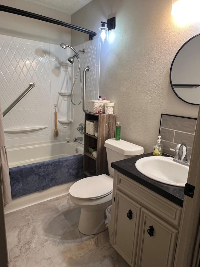 full bath featuring vanity,  shower combination, toilet, and a textured wall