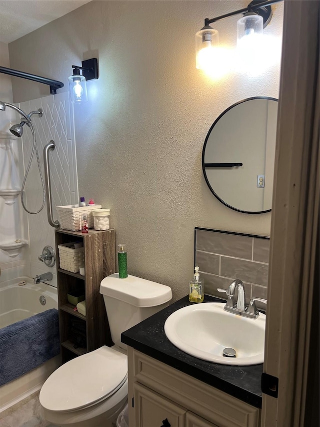 bathroom featuring tasteful backsplash, toilet, shower / bathtub combination, a textured wall, and vanity