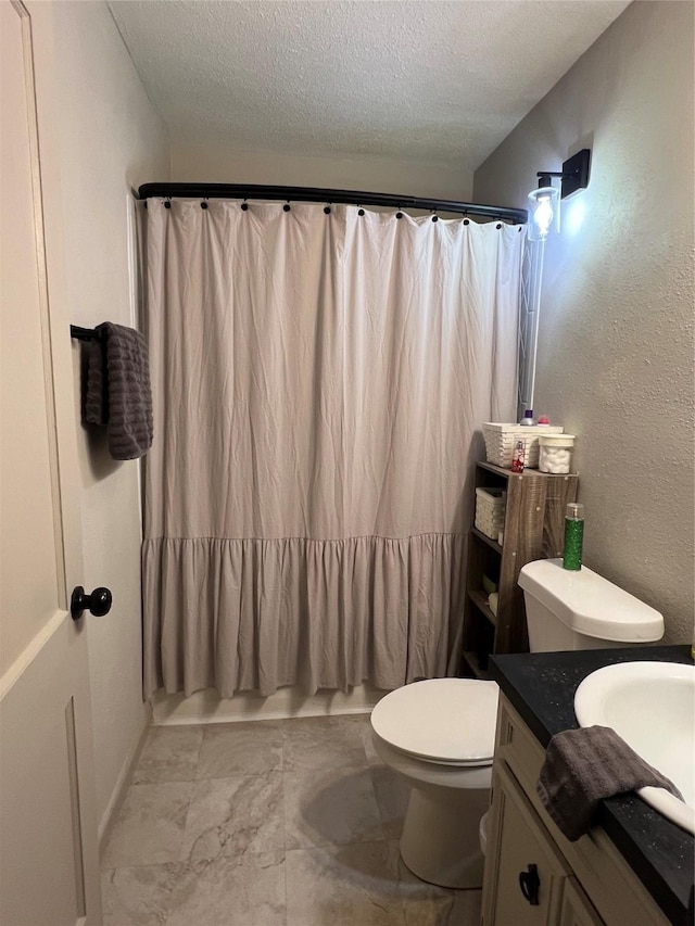 full bath featuring toilet, curtained shower, a textured ceiling, and vanity