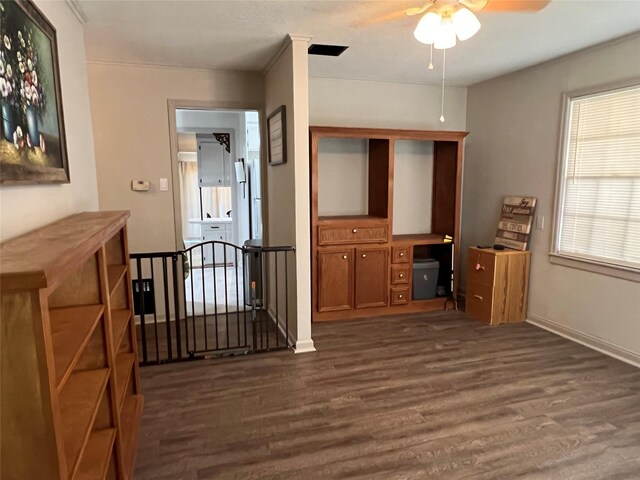 hall featuring baseboards, an upstairs landing, and dark wood finished floors