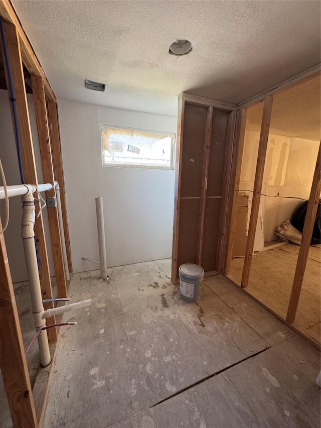 miscellaneous room with a textured ceiling