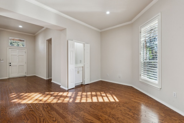 empty room featuring crown molding and dark wood-type flooring