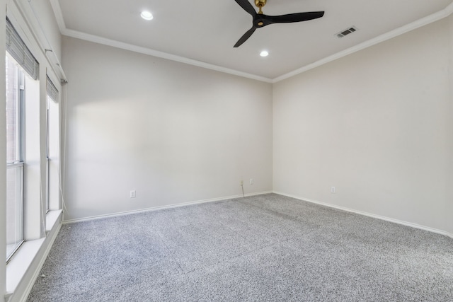 carpeted spare room with crown molding and ceiling fan