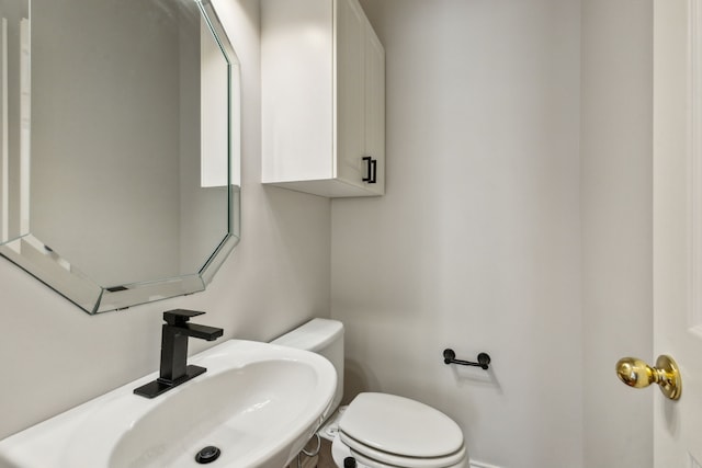 bathroom featuring sink and toilet