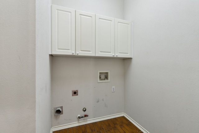 clothes washing area with cabinets, dark hardwood / wood-style floors, hookup for a washing machine, hookup for an electric dryer, and hookup for a gas dryer