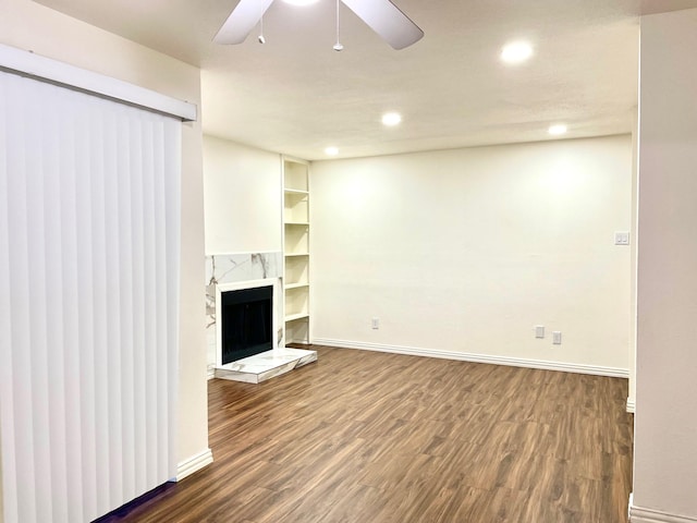 18333 Roehampton Dr Unit 813, Dallas, TX 75252 - unfurnished living room with baseboards, wood finished floors, a premium fireplace, and a ceiling fan