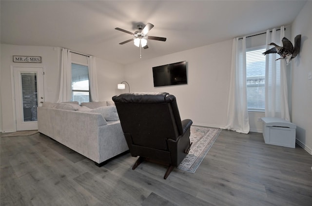 living room with hardwood / wood-style flooring, plenty of natural light, and ceiling fan