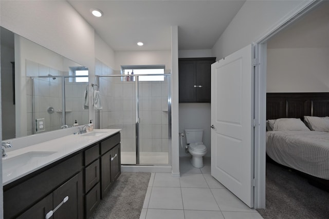 bathroom featuring tile patterned floors, toilet, an enclosed shower, and vanity