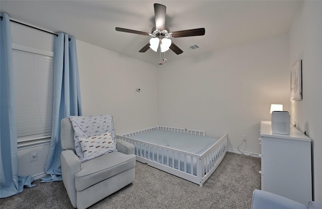 bedroom featuring ceiling fan and carpet