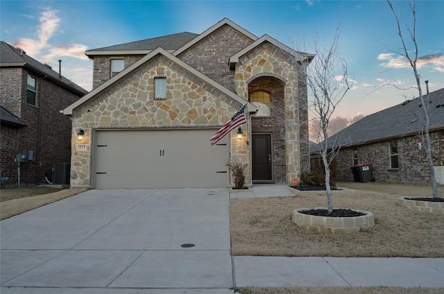 view of front of home featuring central AC and a garage