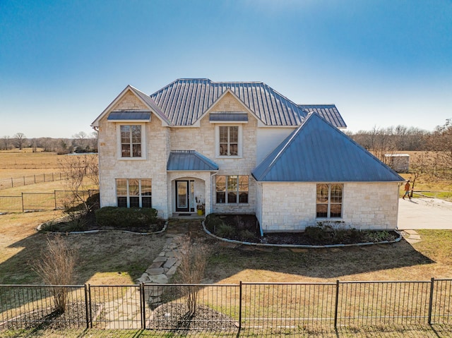 view of front of house with a rural view and a front yard