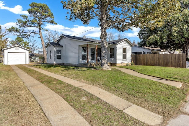 view of front of property featuring a porch, a garage, an outdoor structure, and a front yard