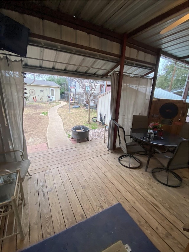 wooden deck featuring a playground