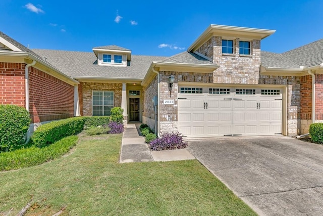 view of front of property with a garage and a front yard