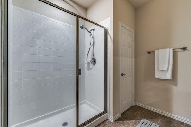 bathroom with tile patterned flooring and a shower with shower door