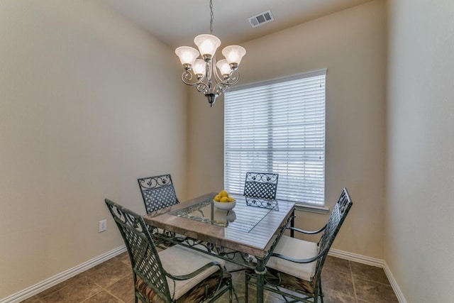 tiled dining area with an inviting chandelier