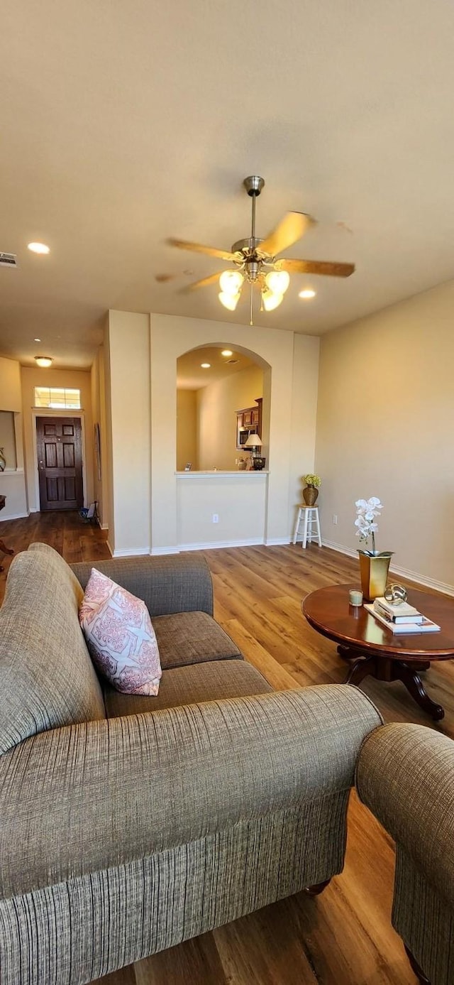 2821 Fordham Rd, Plano, TX 75025 - living room with wood finished floors, baseboards, a ceiling fan, recessed lighting, and arched walkways