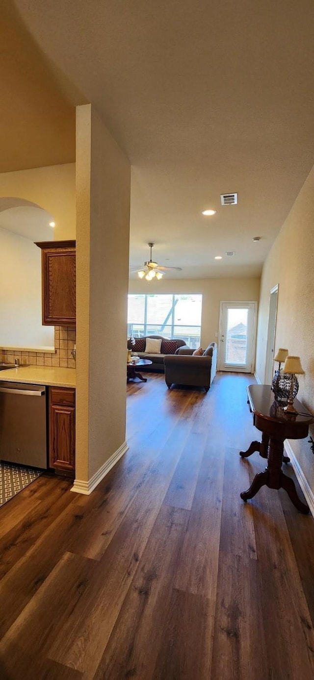 2821 Fordham Rd, Plano, TX 75025 - living room featuring dark wood finished floors, arched walkways, a ceiling fan, baseboards, and recessed lighting