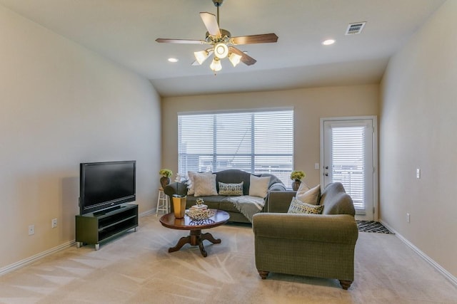 living room featuring vaulted ceiling, light colored carpet, and ceiling fan