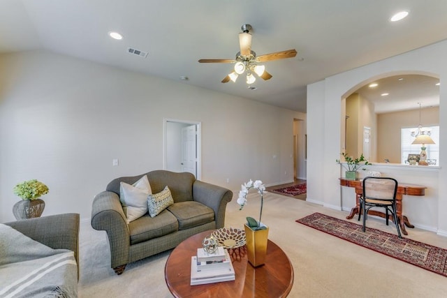 living room featuring vaulted ceiling, carpet floors, and ceiling fan