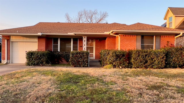 single story home featuring a garage and a front yard