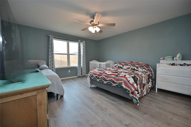 bedroom with hardwood / wood-style floors and ceiling fan