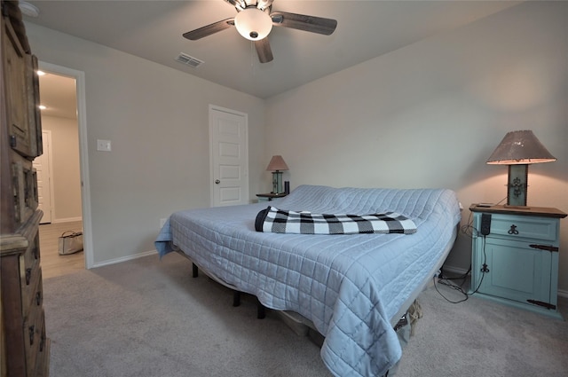 bedroom featuring light carpet and ceiling fan