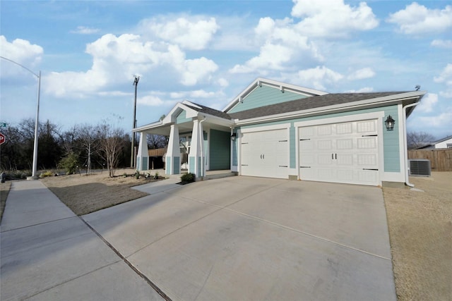 view of front of house with central AC, a porch, and a garage