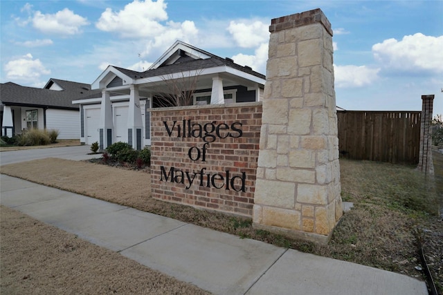 community sign featuring a lawn