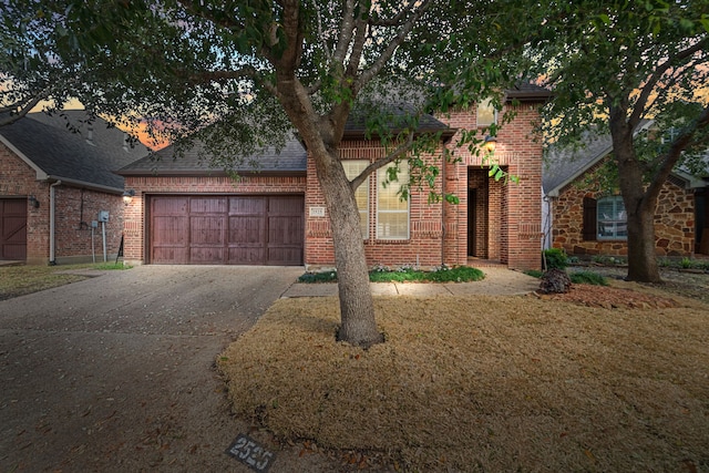 view of front of property featuring a yard and a garage