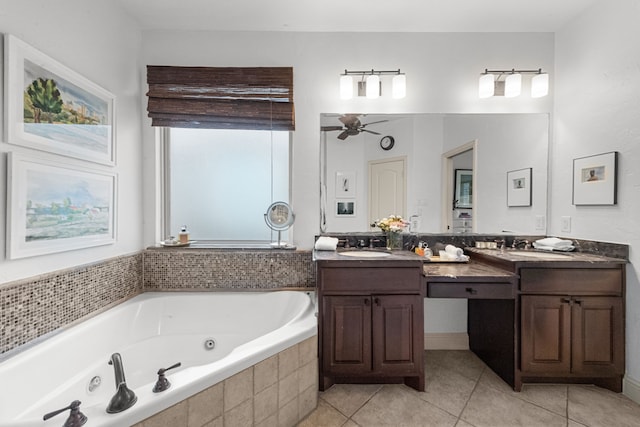 bathroom featuring tile patterned flooring, vanity, tiled bath, and ceiling fan