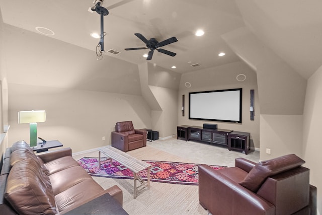 home theater with ceiling fan, vaulted ceiling, and light carpet