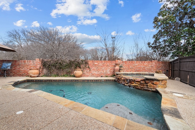 view of swimming pool featuring an in ground hot tub, pool water feature, and a patio