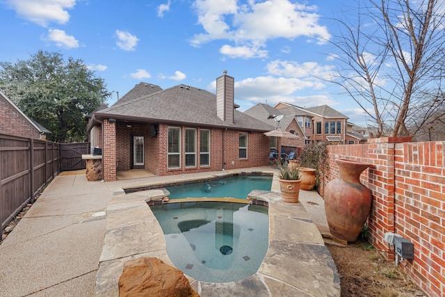 view of swimming pool featuring a patio and an in ground hot tub