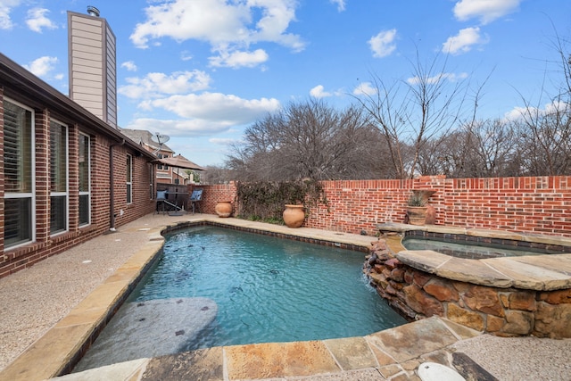 view of pool with an in ground hot tub