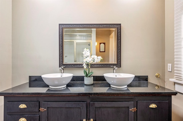 bathroom with walk in shower and vanity