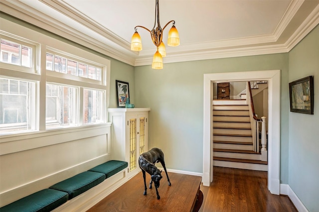 sitting room with crown molding, dark wood-type flooring, and a chandelier